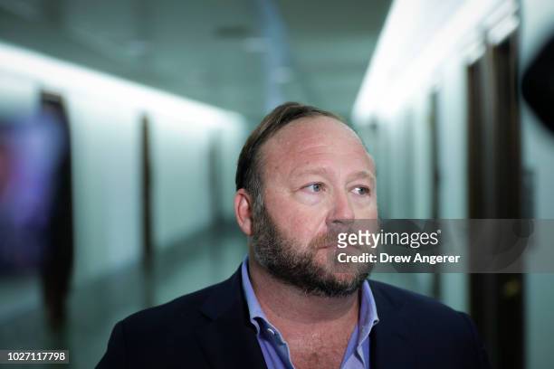 Alex Jones of InfoWars talks to reporters outside a Senate Intelligence Committee hearing concerning foreign influence operations' use of social...