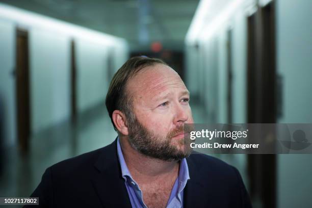 Alex Jones of InfoWars talks to reporters outside a Senate Intelligence Committee hearing concerning foreign influence operations' use of social...