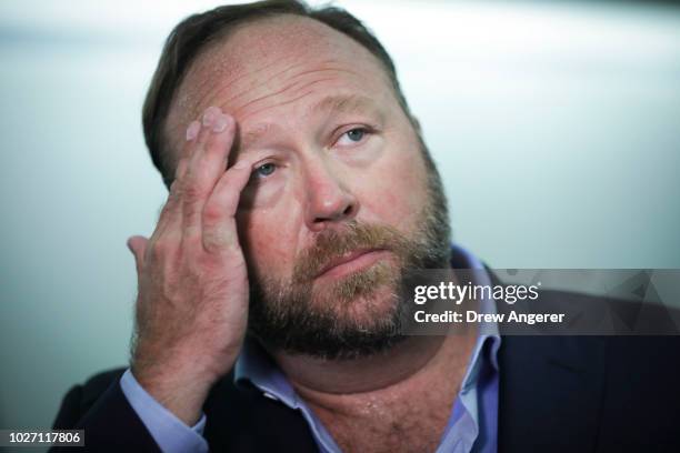 Alex Jones of InfoWars talks to reporters outside a Senate Intelligence Committee hearing concerning foreign influence operations' use of social...