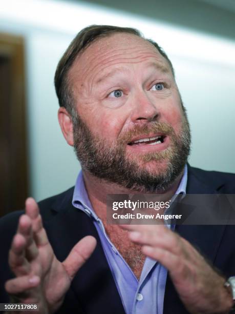 Alex Jones of InfoWars talks to reporters outside a Senate Intelligence Committee hearing concerning foreign influence operations' use of social...