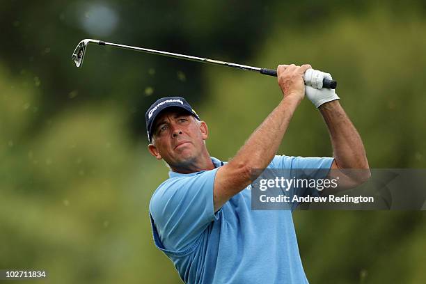 Tom Lehman of the USA plays an approach shot on the 12th hole during round one of The Barclays Scottish Open at Loch Lomond Golf Club on July 8, 2010...