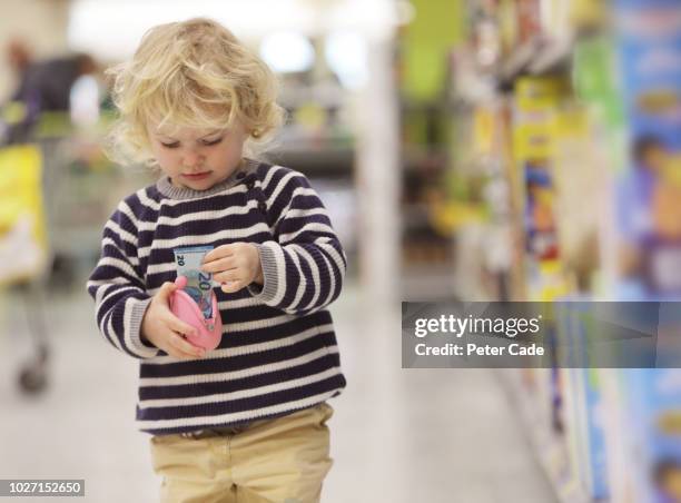 toddler taking money out of wallet in shop - allowance bildbanksfoton och bilder