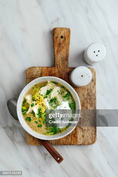 quinoa chicken soup with herby lemon - chicken soup cup stock pictures, royalty-free photos & images