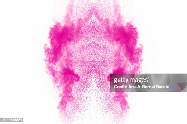 full frame of forms and textures of an explosion of powder and smoke of color pink on a white background. - zachtroze stockfoto's en -beelden
