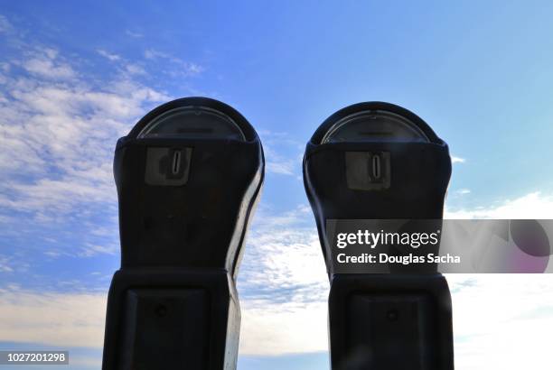 silhouette of two parking meters - corruption abstract stock pictures, royalty-free photos & images