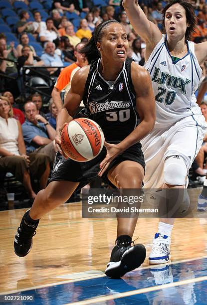 Helen Darling of the San Antonio Silver Stars drives to the basket against Nuria Martinez of the Minnesota Lynx during the game on July 8, 2010 at...