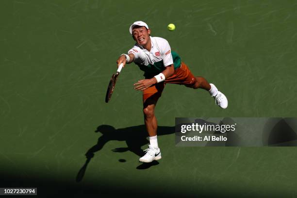 Kei Nishikori of Japan returns the ball during his men's singles quarter-final match against Marin Cilic of Croatia on Day Ten of the 2018 US Open at...