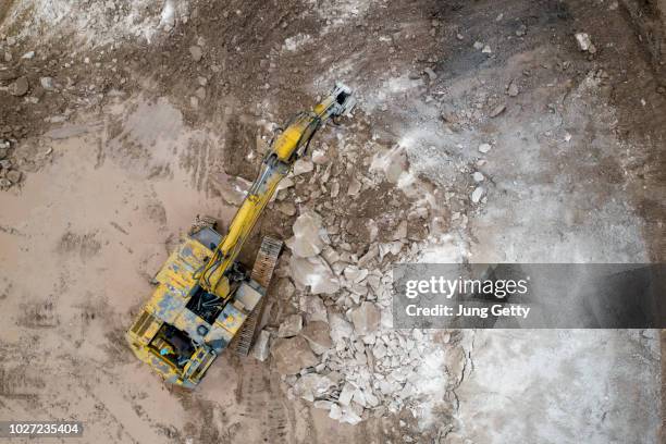 aerial view excavator at construction site - heavy demolition stock-fotos und bilder