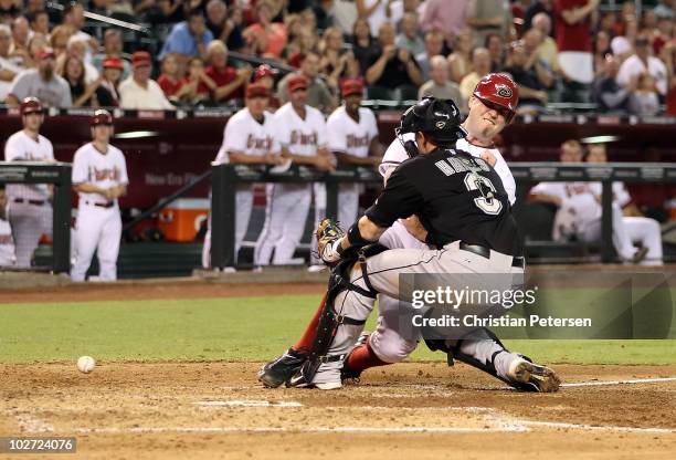 Chris Snyder of the Arizona Diamondbacks collides with catcher Brett Hayes of the Florida Marlins as he slides in to score a run during the fourth...