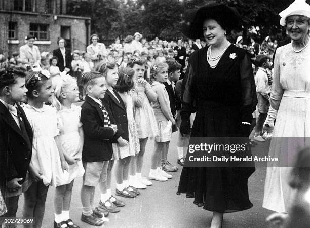 The Queen Mother visiting Peterborough School, Fulham, London, 17 July 1952." 'The Queen Mother paid a visit to the Peterborough School, Fulham, and...