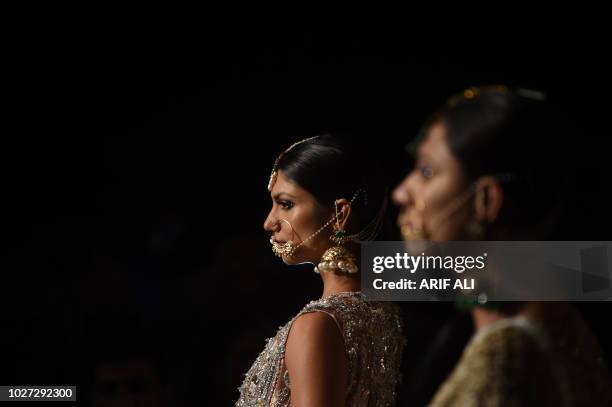 Models present creations of designer Nadia Azwer during the Pakistan Fashion Design Council L'Oreal Paris Bridal Week 2018, in Lahore on September 5,...