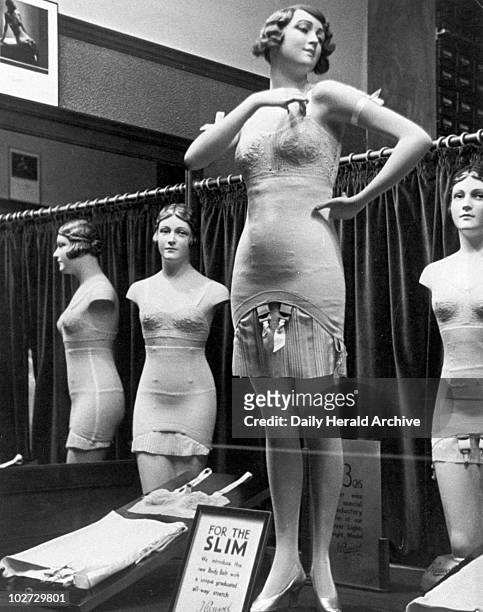 Shop window display of underwear, c 1935. Photograph showing a display of underwear in a lingerie shop including the 'Body Belt'. The notice reads:...