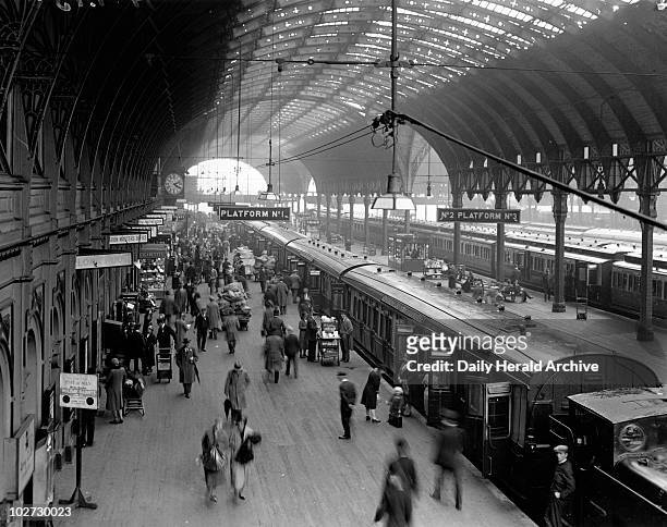 Paddington Station, London, 10 June 1931. Photograph by Harold Tomlin showing a busy scene on platform 1 with passengers and porters. Paddington...
