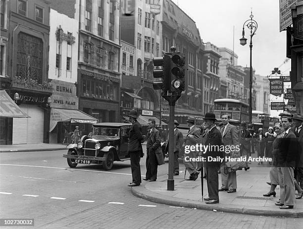 New traffic signals in operation, Oxford Street, London, 5 July 1931. Photograph by Harold Tomlin. New traffic signals in operation, Oxford Street,...