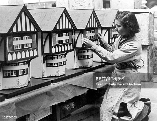 Putting the finishing touches to doll's houses, 1 December 1936. Putting the finishing touches to doll's houses, 1 December 1936. 'Modernism hasn't...