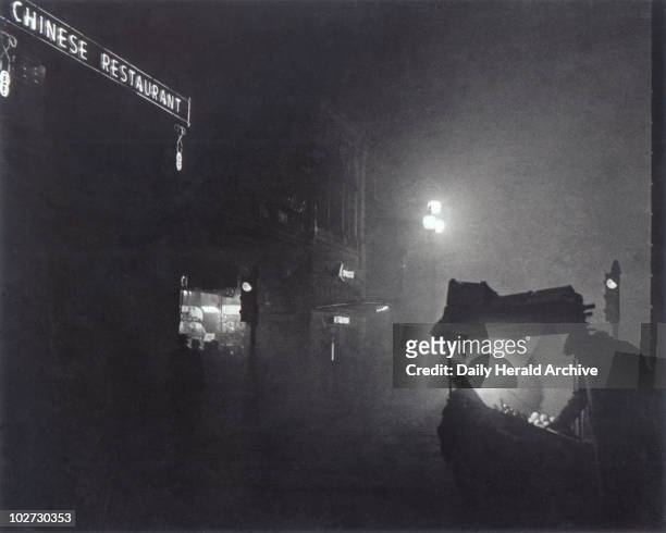 Foggy Piccadilly partially lit by the light from a fruit seller's stall, 1952. Foggy London scene, 7 December 1952.