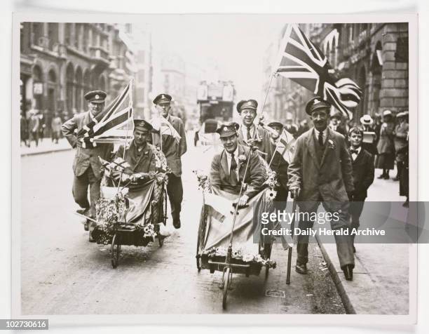 Peace scenes in London wounded soldiers with flags', 1919. A photograph of victory celebrations after the end of the Great War, taken by an unknown...