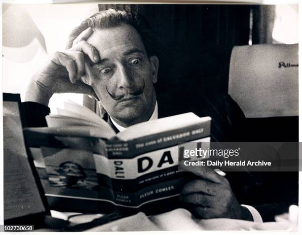 Salvador Dali reading his biography, 6 May, 1959. A photograph of the Spanish artist Salvador Dali , taken by Terry Fincher for the Daily Herald...