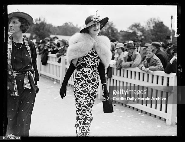 Woman at Royal Ascot, 1935. A photograph of a woman walking past the crowds on the second day of Royal Ascot for the Royal Hunt Cup, taken by Edward...