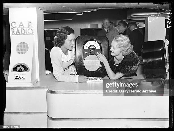 Women with an Ekco portable radio, Radiolympia, London, 1935. A photograph of a two women with an Ekco portable radio, taken by George Woodbine for...