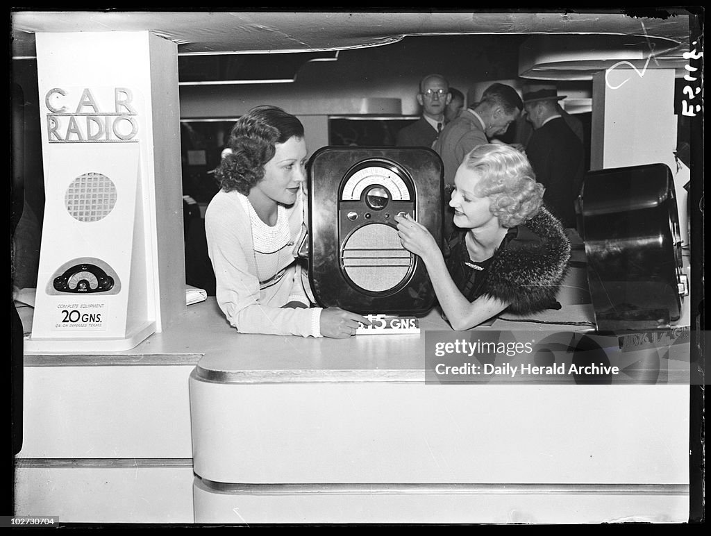 Women with an Ekco portable radio, Radiolympia, London, 1935.
