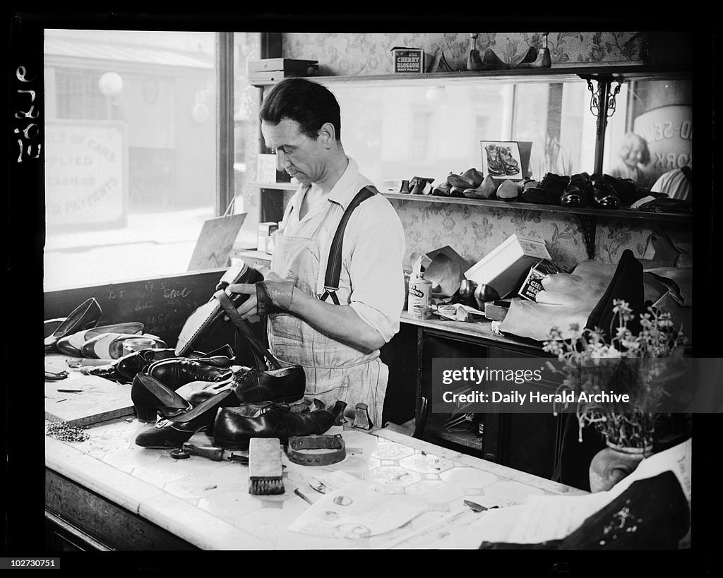 Cobbler at work, c 1935.
