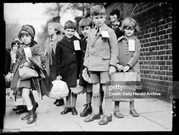 School children being evacuated from London, 28 September 1938. Children being evacuated from London.These evacuees, carrying a few possessions in...