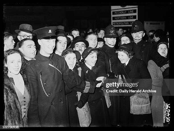 Crowd of Wrens, 1941. A photograph of police holding back a crowd of Women's Royal Naval Servicewomen at a London station, taken by Calcraft for the...