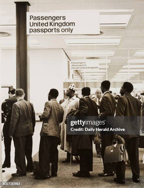 Nigerian immigrants, London Airport, 1 July 1962. Passengers from BOAC flight 264 from Lagos pass from the arrivals lounge into the immigration...