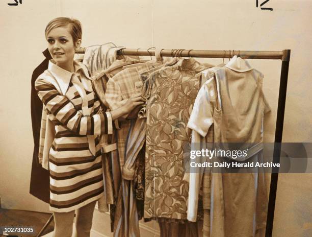 Twiggy with rail of 'Twiggy Clothes', 1967. A photograph of Twiggy, real name Lesley Hornby , with a rail of 'Twiggy Clothes', taken by Tony Eyles...