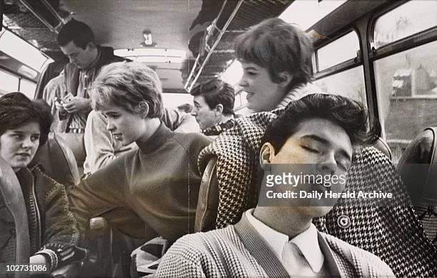 Cliff Richard asleep on a coach while on tour, 1963. Cliff Richard rests on the tour bus during his annual 42 day Grand tour of Britain, 1963.