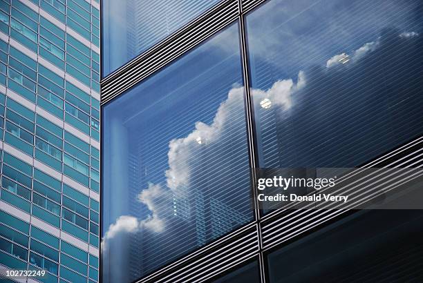 clouds reflected in window - skyscraper cloud stock pictures, royalty-free photos & images