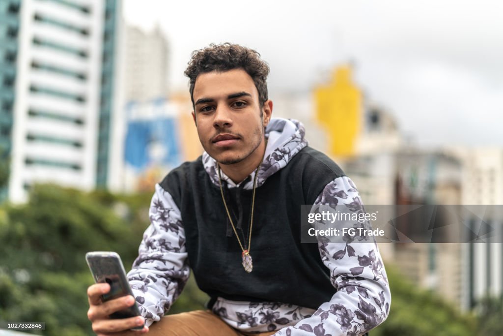 Young Men Using Mobile Portrait at city on background