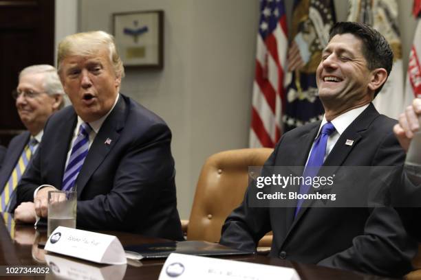 House Speaker Paul Ryan, a Republican from Wisconsin, right, laughs as U.S. President Donald Trump speaks during a meeting with Republican...