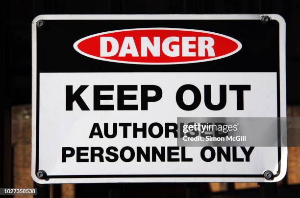 'danger: keep out. authorised personnel only' sign on fence railings - keep out sign stock pictures, royalty-free photos & images