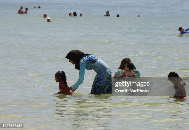 Muslim woman wearing a burkini while enjoying the warm water in the Gulf of Mexico at San Marco Beach on Marco Island, Florida, USA, on 1st September...