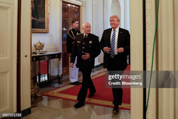 President Donald Trump, right, arrives for a meeting with sheriffs from across the country at the White House in Washington, D.C., U.S., on...