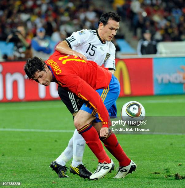 Joan Capdevila of Spain tackled by Piotr Trochowski of Germany during the 2010 FIFA World Cup South Africa Semi Final match between Germany and Spain...