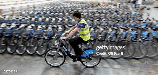 Workman test rides one of the fleet of bicycles which are to be used in London's new cycle hire scheme on July 9, 2010 in London, England. The...
