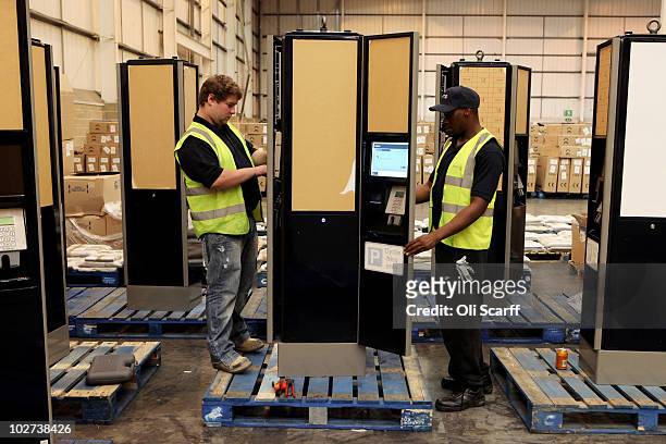 Workmen put the finishing touches to the payment terminals for the fleet of bicycles which are to be used in London's new cycle hire scheme on July...