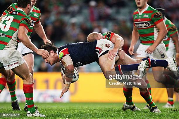 Jared Waerea-Hargreaves of the Roosters is tackled by Michael Crocker of the Rabbitohs during the round 18 NRL match between the Sydney Roosters and...