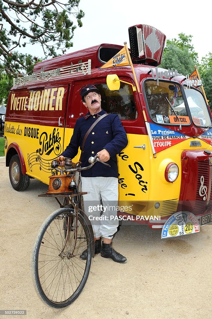 A postman performer poses in front of an
