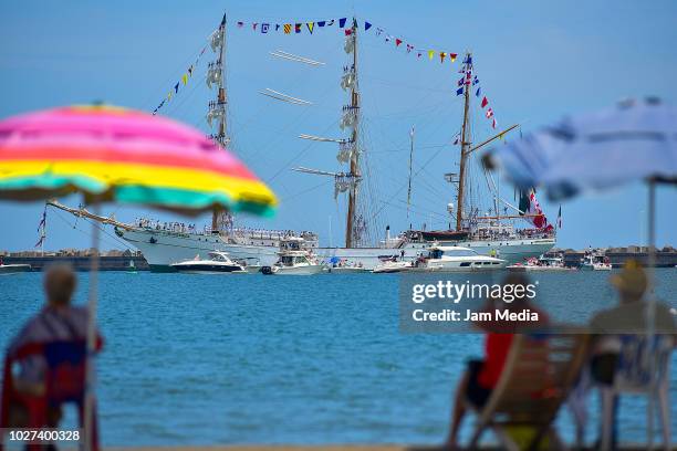 People watch Mexican Sailboat Cuauhtemoc from the beach as part of Festival Velas Cozumel/Veracruz 2018 at the port of Veracruz on August 27, 2018 in...