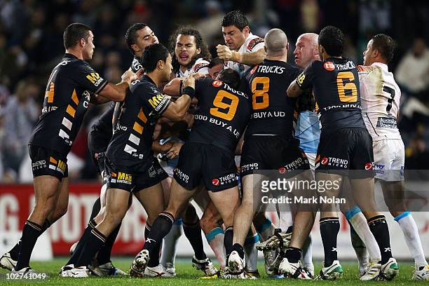 Tigers and Titans players become involved in a fight during the round 18 NRL match between the Wests Tigers and the Gold Coast Titans at Campelltown...