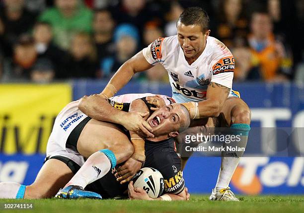 Bryce Gibbs of the Tigers complains to the referee about a high tackle during the round 18 NRL match between the Wests Tigers and the Gold Coast...