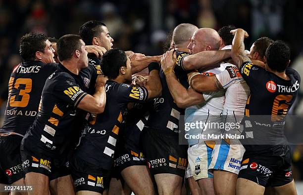 Tigers and Titans players become involved in a fight during the round 18 NRL match between the Wests Tigers and the Gold Coast Titans at Campelltown...