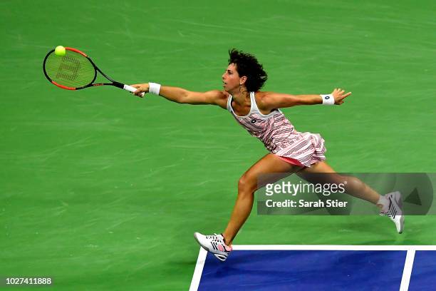 Carla Suarez Navarro of Spain returns the ball during her women's singles quarter-final match against Madison Keys of the United States on Day Ten of...