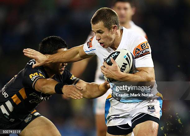 William Zillman of the Raiders is tackled during the round 18 NRL match between the Wests Tigers and the Gold Coast Titans at Campelltown Sports...