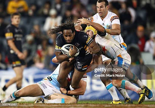 Lote Tuqiri of the Tigers is tackled during the round 18 NRL match between the Wests Tigers and the Gold Coast Titans at Campelltown Sports Stadium...