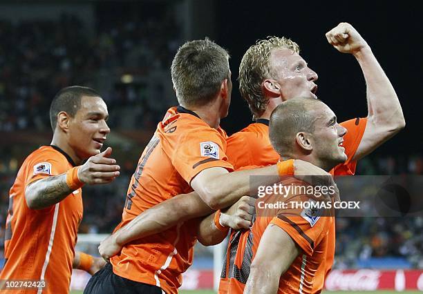 Netherlands' players celebrate after midfielder Wesley Sneijder scored his team's second goal during the 2010 World Cup round of 16 football match...